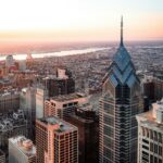Philadelphia skyline in morning with view of river and sunrise.